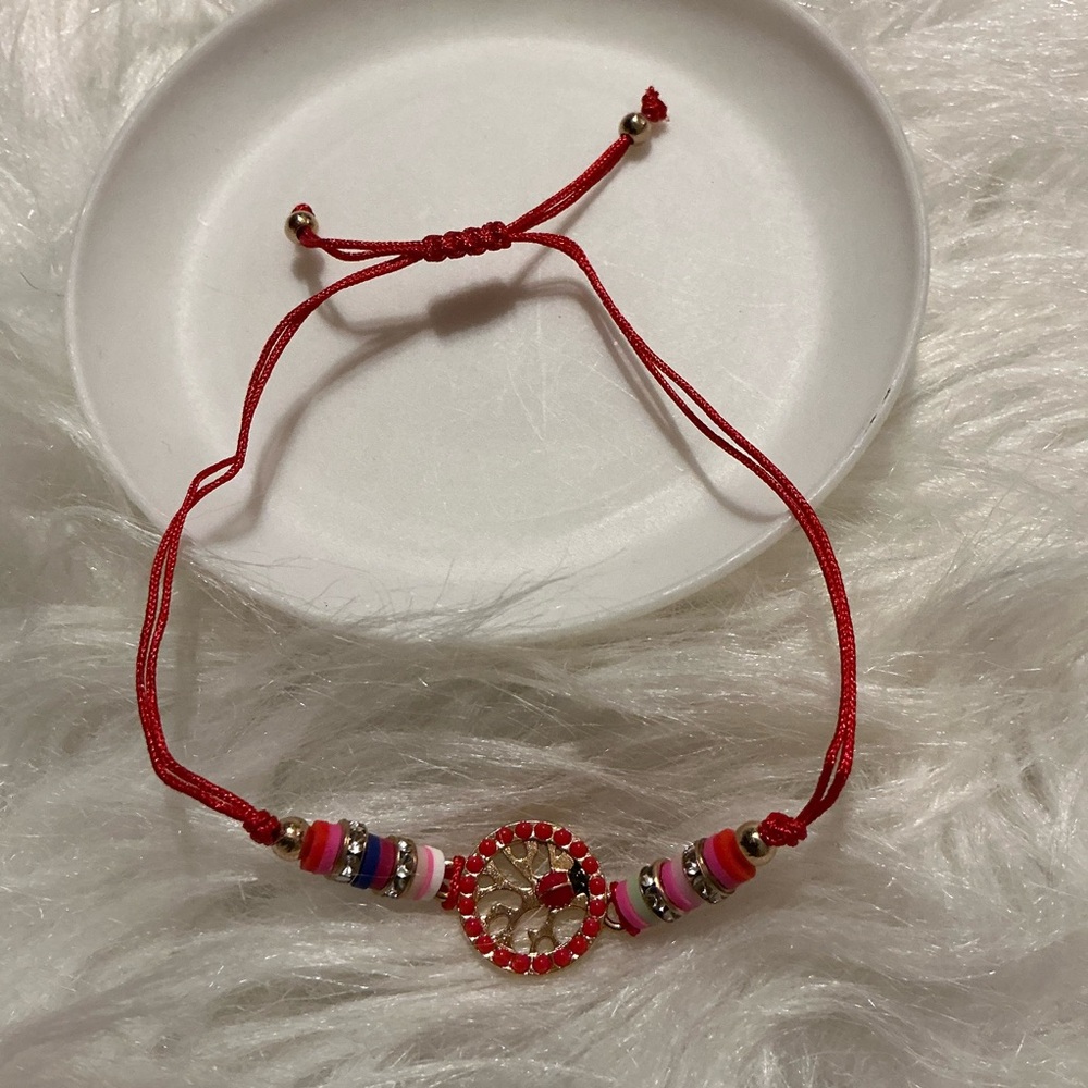 Red string and ladybug charm bracelet